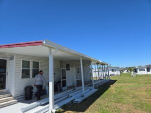 Carport adds usable space to the outside of mobile home.